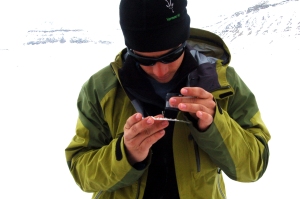 Studying the size of ice crystals using a loupe and a millimetre-square meausuring card. Photo: Bonnie Laverock